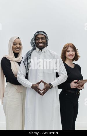 Der arabische Geschäftsmann steht selbstbewusst neben zwei Geschäftsfrauen und stellt ein kompetentes und vielfältiges Team dar, das Ambitionen, Innovation und verkörpert Stockfoto