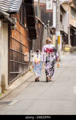 Japanisches Mädchen mit traditionellem Kimono Yukata auf der Straße in Kyoto, Japan. Stockfoto