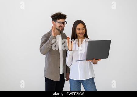 Zwei professionelle indische Kollegen diskutieren Online-Anwendungen für Unternehmen, schauen sich das Internet-Startup-Projekt an und sprechen auf der Runde über Videoanrufe Stockfoto