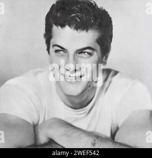 Ein Porträt des Schauspielers Tony Curtis, bekannt für seine Rollen in Filmen wie The Prince Who Was a Thief (1951). In diesem Abenteuerfilm spielt Curtis Julna, einen charismatischen und gewagten jungen Mann, der sich auf die Suche nach Gerechtigkeit und der Rückeroberung seines Geburtsrechts macht. Stockfoto