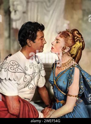 Robert Taylor und Deborah Kerr spielen in "Quo Vadis?" (1951), ein historisches Epos, das im antiken Rom spielt. Im Film stellt Taylor Marcus Vinicius, einen römischen Militärkommandanten dar, während Kerr Lygia spielt, eine christliche Geisel adeliger Geburt. Die Erzählung entfaltet sich gegen die Größe und Dekadenz von Neros Rom und stellt die Opulenz des Reiches dem aufkommenden christlichen Glauben gegenüber. Stockfoto