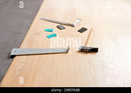 Planken von Laminatboden und Werkzeuge, um sie zu installieren Stockfoto