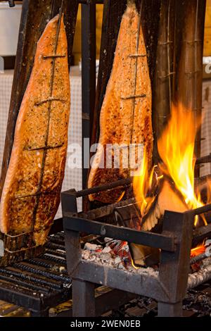 Gegrillter Lachs in einer Feuerschüssel, Lachsfilets über offener Flamme gegrillt, Fisch gekocht, Spezialitäten aus Finnland, Leumulohi, Snackbar, Markt Stockfoto