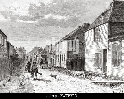 Das tägliche Leben in der Pariser Straße der Stadt Saint-Pierre, der Hauptstadt von Saint Pierre und Miquelon, Terra Nova. Neufundland und Labrador, Kanada. Französische Küste der Insel Neufundland 1886 von Leutnant Louis Koenig (1847–1920) Stockfoto