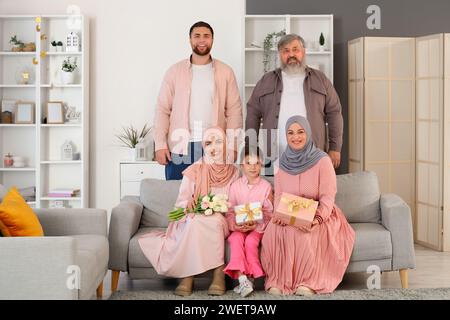 Glückliche muslimische Familie mit Geschenken zu Hause. Ramadan-Feier Stockfoto