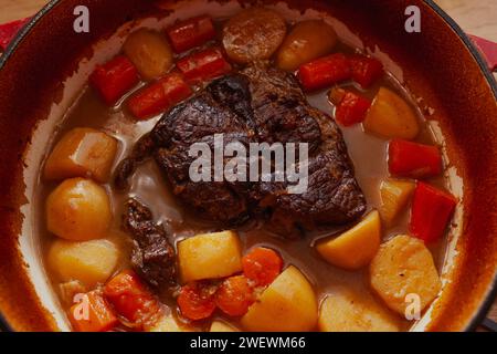 Gebratener Topf mit Karotten und Kartoffeln, langsam im roten holländischen Ofen gekocht, Blick von oben Stockfoto