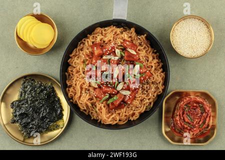 Top View Full Set Rapokki oder Rabokki, Tteokbokki mit koreanischer Ramen Instan Nudel, mit Kimchi, Danmuji und Nori Laver Stockfoto