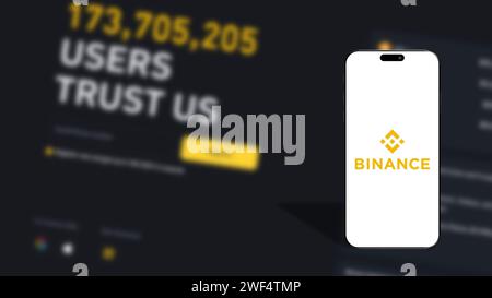 Istanbul, Türkei - 25. Januar 2024: Logo der Marke Binance auf dem Smartphone-Bildschirm mit der Binance-Website im Hintergrund. Binance ist eine globale Kryptowährung exc Stockfoto