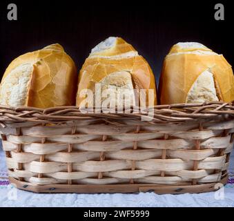 Vier frische Baguettes, die ordentlich in einem bezaubernden Korb angeordnet sind Stockfoto