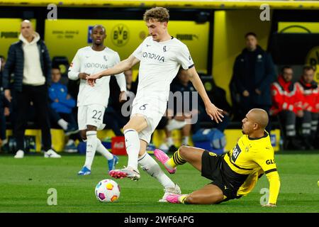 Dortmund, Deutschland. Januar 2024. Donyell Malen (R) von Borussia Dortmund streitet mit Patrick Osterhage vom VfL Bochum im ersten Bundesliga-Spiel zwischen Borussia Dortmund und VfL Bochum am 28. Januar 2024 in Dortmund. Quelle: Joachim Bywaletz/Xinhua/Alamy Live News Stockfoto