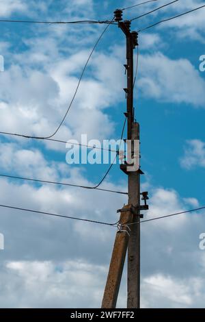 Alte Stromleitung gegen blauen Himmel Stockfoto