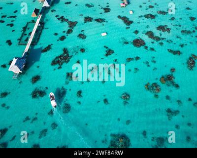 Drohnenaufnahme des Piers in der Lagune Fakarava mit Perlenfarm und Boot. Französisch-Polynesien Stockfoto