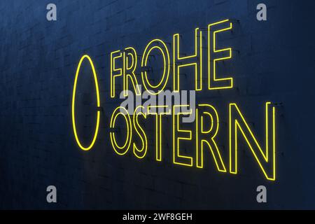 Deutscher Text „Frohe Ostern“ Neonschild mit einem Ei an einer weißen, blau beleuchteten Ziegelwand Stockfoto