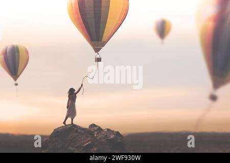 Die Frau versucht, den Faden zu fangen, der von einem Heißluftballon herunterkommt, der frei in den Himmel entkommt, Konzept von Reise und Abenteuer Stockfoto