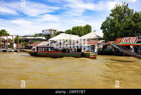 Eine friedliche Szene mit zwei Booten, die auf dem ruhigen Fluss schwimmen, mit üppigem Grün im Hintergrund. Stockfoto