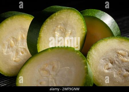 Zucchini-Scheiben auf schwarzem Hintergrund Stockfoto