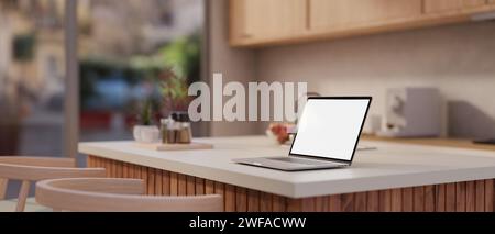 Seitenansicht eines Laptops mit weißem Bildschirm auf einer Kücheninsel in einer modernen, minimalistischen Küche. Home Workspace, Remote-Arbeitsplatz. 3D-Rendering, Stockfoto
