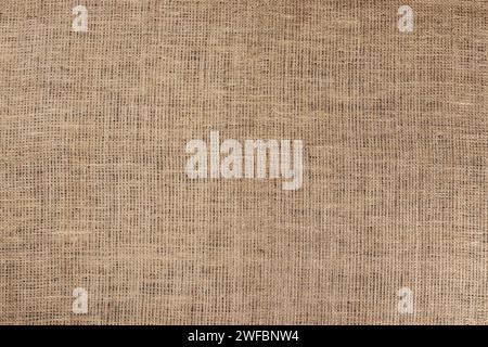 Jute hessischer Sacktuch Leinwand Sack Tuch gewebte Textur Muster Hintergrund in gelber beige Creme braune Farbe, Stockfoto