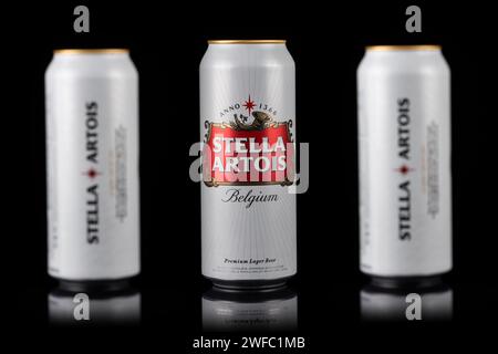 Ukraine. Dnipro. 20. märz 2023: Drei weiße Dosen des großen belgischen Biers Stella Artois auf schwarzem Hintergrund. Alu-Dose Stella Artois Bier auf Schwarz Stockfoto