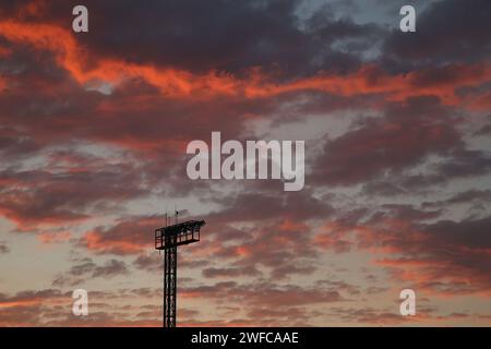 Flutlichter vor einer Wolkenbildung bei Sonnenuntergang Stockfoto