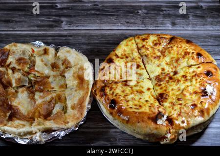 Hintergrund des mehrschichtigen gebackenen Pizzakuchens, besteht aus Schichten von Salami, Grillhähnchen, Käsemischung, Rindfleisch, Wurst, Mozzarella-Käse und Fleischsau Stockfoto