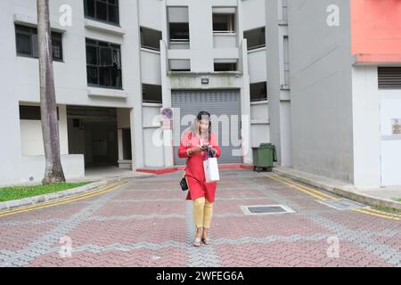 Ethnische Indianerin geht aus einem HDB-Block in Sengkang, Nordosten Singapurs Stockfoto