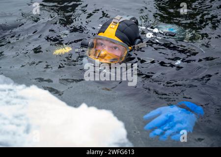 Little Falls, Minnesota, USA. Januar 2024. Ein U.S. Navy Diver, der der Mobile Diving and Salvage Unit (MDSU) 2 zugeteilt ist, taucht in simulierten arktischen Gewässern als Teil der Snow Crab Übung 24-1. SNOWCRABEX ist eine jährliche Übung, die dazu dient, die Fähigkeiten und Ausrüstung der U.S. Navy EOD und Navy Diver in einer simulierten arktischen Umgebung zu testen und zu evaluieren und die Kampfwirkung zu verbessern. Navy EOD und Navy Divers sind Teil der Navy Expeditionary Combat Force (NECF), die es der US Navy ermöglicht, den Schlachtraum zu räumen und zu schützen. (Kreditbild: © U.S. Navy/ZUMA Press Wire) NUR REDAKTIONELLE VERWENDUNG! Stockfoto