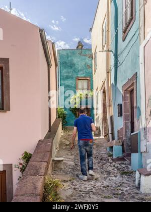 Mann, der in einer Straße in der Stadt Bosa, Sardinien, Italien läuft Stockfoto