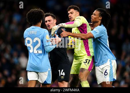 Manchester Citys Rico Lewis (links) und Burnleys Connor Roberts (zweiter links) treffen aufeinander, als Manchester City Torhüter Ederson und Nathan Ake versuchen, die beiden während des Premier League-Spiels im Etihad Stadium in Manchester zu trennen. Bilddatum: Mittwoch, 31. Januar 2024. Stockfoto