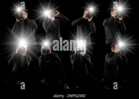 Gruppe von Fotografen mit Kameras auf schwarzem Hintergrund. Paparazzi machen Bilder mit Blitzen Stockfoto