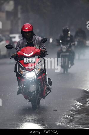 NOIDA, INDIEN - JANUAR 31: Pendler bei leichtem Regen im Winter, am 31. Januar 2024 in Noida, Indien. Es gab leichten Regen in Delhi NCR an einem kalten Tag, was die starke Kälte in Nordindien verstärkte. Heute wird es leichten Regen in Delhi-NCR geben. Laut IMD betrug die Mindesttemperatur 11 Grad Celsius. (Foto: Sunil Ghosh/Hindustan Times/SIPA USA) Credit: SIPA USA/Alamy Live News Stockfoto