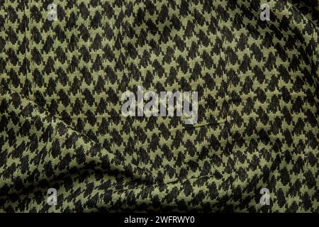 Keffieh Schal. Die Textur des traditionellen Baumwoll-symbolischen arabischen Schals. Khaki Hintergrund. Stockfoto