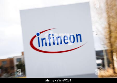 Neubiberg, Deutschland. Januar 2024. Das Infineon-Logo auf einer Säule am Rande des Campeon, Hauptsitz der Infineon Technologies AG, deutscher Halbleiterhersteller. (Aufnahme mit langsamer Verschlusszeit und Zoom-Effekt) Credit: Matthias Balk/dpa/Alamy Live News Stockfoto