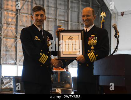 NAS PATUXENT RIVER, Maryland (10. Januar 2024) – Kapitän Derrick Kingsley, verlassen, erhält seine Bescheinigung über den Ruhestand von Kapitän Douglas Burfield bei der NAS Patuxent River Change of Command Zeremonie am 10. Januar. Burfield übernahm das Kommando über die Flugstation von Kingsley, die nach 27 Jahren Marinedienst in den Ruhestand ging. Stockfoto