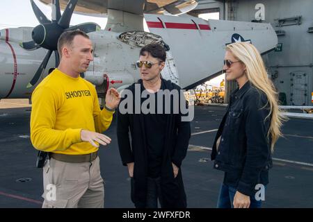 240120-N-TY704-1041 PHILIPPINE SEA (20. Januar 2024) Lt. Austin Starner, ein gebürtiger aus Phoenix Arizona, gibt Jamelle und Brandon Fraley, Mitglieder der Two Story Road, eine Tour durch das Cockpit an Bord des Flugzeugträgers USS Carl Vinson (CVN 70) der Nimitz-Klasse. Vinson, das Flaggschiff der Carrier Strike Group ONE, wird im Einsatzgebiet der 7. US-Flotte eingesetzt, um einen freien und offenen Indo-Pazifik zu unterstützen. Stockfoto