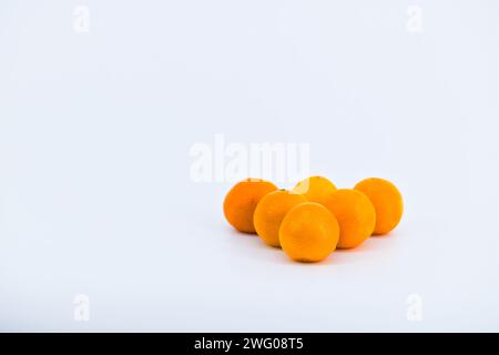 Eine entzückende Komposition, die die Frische von Mandarinen vor einem sauberen weißen Hintergrund einfängt. Stockfoto