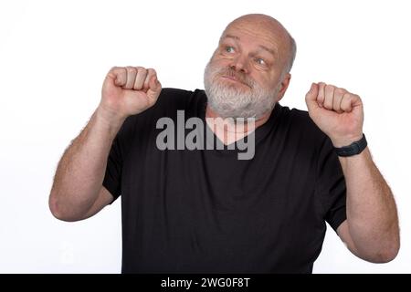Mann mittleren Alters, der Unannehmlichkeiten und Stress mit geballten Fäusten ausdrückt, Gesundheitskonzept auf weißem Hintergrund. Stockfoto