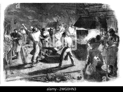 Progress of the International Exhibition Building: The Forge, [London], 1862. Ansicht von '...einem Teil der Arbeiten, die im Gebäude für die große Ausstellung stattfinden, der gut berechnet ist, um eine Vorstellung von der Weite der Betriebe zu geben..."die Schmiede"... ist ein Abschnitt einer langen Reihe ähnlicher Öfen, die in einem großen Schuppen platziert sind, das erstreckt sich entlang der Westseite des Gebäudes von der Vorderseite in der Cromwell-Road und liegt in der Prince Albert-Road. Es wird bescheiden als „The Smith's Shop“ bezeichnet, ist aber tatsächlich eine Zyklopenbaracke, in der sich zahlreiche Brände befinden Stockfoto