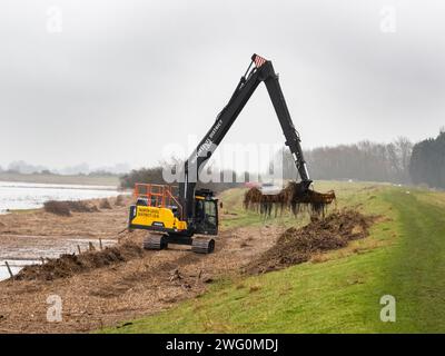 Eine Maschine, die Flutschutt aus einem Entwässerungsgraben auf den Nene-Waschanlagen in Cambridgeshire, Großbritannien, entfernt. Stockfoto