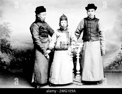 Zwei Männer und eine Frau mit asiatischem Aussehen, 1880. Aus einer Sammlung von 71 Objekten (Fotografien und negative auf Glas), die im späten 19. Und frühen 20. Jahrhundert von dem berühmten revolutionär-populistischen und sozialen und politischen Aktivisten N.A. Charushin (1851–1937) und von N. Petrov hergestellt wurden. Charushin verbüßte 1878 eine Zwangsarbeitsstrafe im transbaikalen Territorium. Die Sammlung veranschaulicht Aspekte der transbaikalen Geschichte in dieser Zeit, mit einem besonderen Schwerpunkt auf dem Teehandel mit China, das zu dieser Zeit einer der wichtigsten Wirtschaftszweige der Region war. Die Fotos zeigen vari Stockfoto