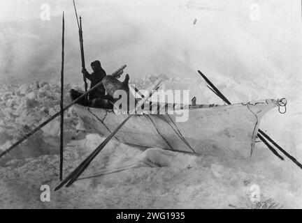 Eskimo in einem Boot mit Fellen, genannt Umiak, zwischen 1900 und 1930. Stockfoto