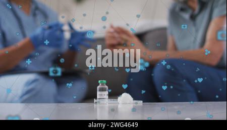 Bild medizinischer Ikonen über afroamerikanischer Ärztin mit Patient Stockfoto