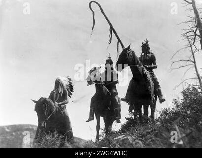 Apsaroke war Group, 1905. Der Druck zeigt drei Krähenindianer, Uphaw, With Way und Packs the hat, auf dem Pferd. Stockfoto