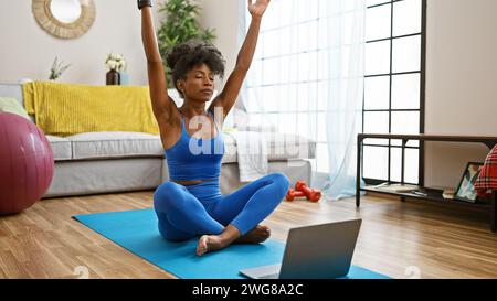 afroamerikanerin, die zu Hause Online-Yoga-Unterricht hat Stockfoto