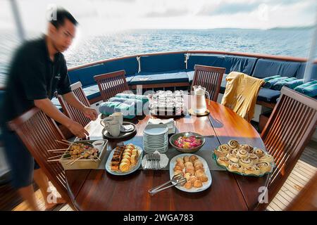 Stewerd mit Snacks auf Tauchsafari Pelagian, Wakatobi Dive Resort, Sulawesi, Indonesien Stockfoto