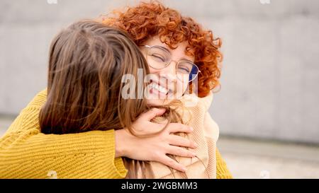 Glückliches Treffen zwischen zwei jungen Freunden auf der Straße Stockfoto