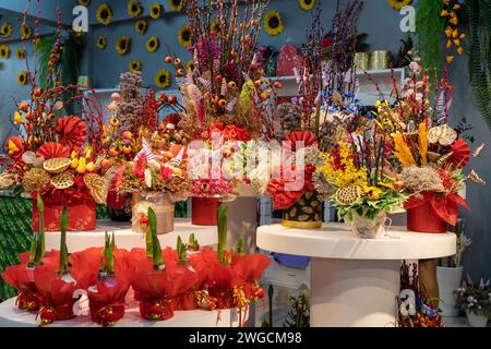 Wunderschönes Schaufenster eines Blumengeschäfts mit einer großen Auswahl an künstlichen Blumendekorationen während des chinesischen Neujahrs. Stockfoto