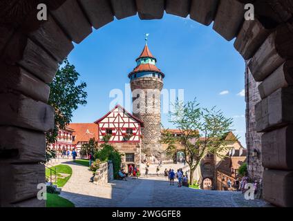 Blick auf den Innenhof der Kaiserburg, die mittelalterliche Burg Nürnberg, mit dem Tiefen Brunnen und dem Sinwellturm. Stockfoto