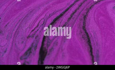 Glitzertinte Textur Farbfluss lila/schwarz Spritzer Stockfoto