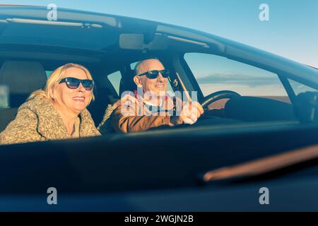 Lächelndes Seniorenpaar, das Auto fährt. Stockfoto